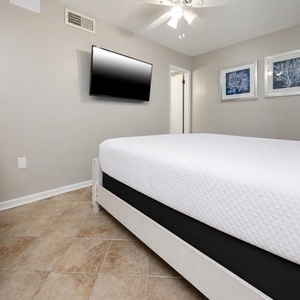 Relaxing guest room with a cozy king bed, a flat-screen TV, and charming decor for a comfortable stay