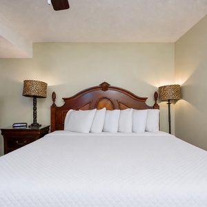 The king suite welcomes you with cozy wood tones and warm light from unique lamps nearby