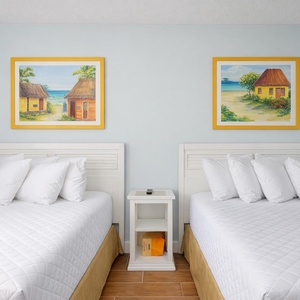 Experience restful nights on plush bedding in this cheerful guest room, enriched by vibrant coastal artwork