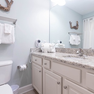 Freshen up in this guest bath in the relaxing shower or soothing tub before an exciting beach day