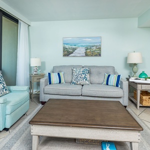 Cozy living room with a couch and two chairs, all with stunning Gulf views