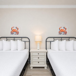 Rest comfortably in this guest room with two cozy queen beds and charming artwork