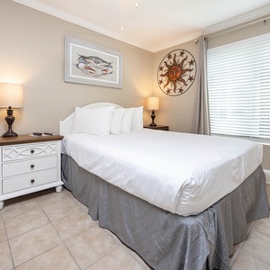 This cozy bedroom features a comfortable bed, warm lighting, and charming decor, perfect for a restful getaway
