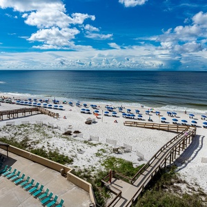 Experience breathtaking views of the sandy beach and vibrant umbrellas from your balcony, perfect for relaxation