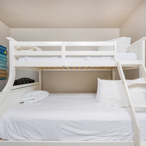 This guest room features a stylish bunk bed with a comfortable double bed below, perfect for family or friends