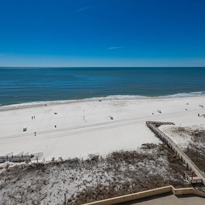 Breathtaking view of soft white sands and gentle waves from a beachfront balcony, perfect for relaxation and enjoyment