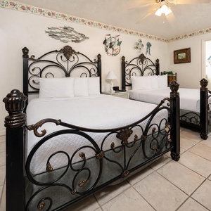 Relax in this charming guest room with two elegant queen beds, tasteful decor, and a welcoming atmosphere