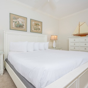 Bright and airy guest bedroom featuring a plush king bed, stylish decor, and soft lighting for a cozy retreat