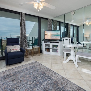 Living area featuring comfy seating with queen sofa-sleeper, TV, and stunning views through floor to ceiling balcony windows