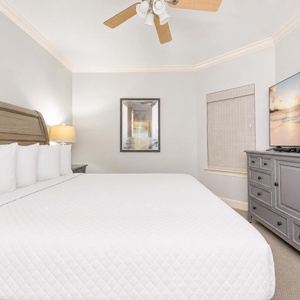 Sink into plush pillows of this king guest suite as soothing ceiling fan breezes accompany your favorite show