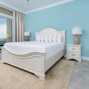 Unwind in the king master suite with beach balcony access, inviting relaxation with captivating coast views