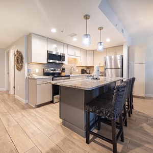 Enjoy cooking in this spacious kitchen with a large island, stainless appliances, and stylish seating for dining