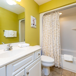 Towels await your touch as you rinse off under the refreshing spray in this guest bathroom shower