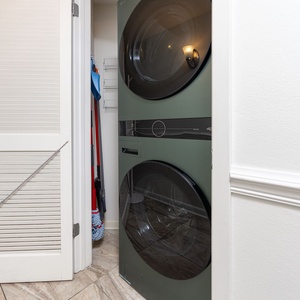 Conveniently access the laundry area featuring modern appliances, making your stay hassle-free and comfortable