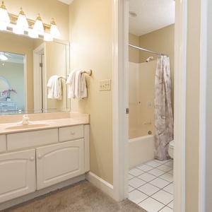 Refresh in this guest bathroom featuring a spacious vanity, elegant fixtures, and soft towels