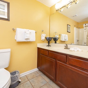 Refresh after a day at the beach in this guest bath with a spacious vanity, fresh towels, and tub-shower combo