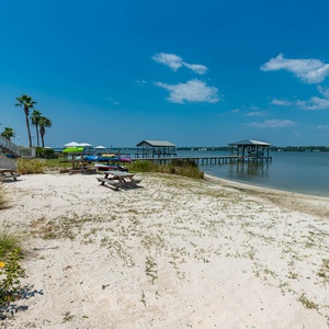 Enjoy the lagoon with picnic spots and easy access to water activities from this inviting sandy area or fish from the dock