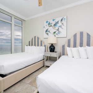 Wake to a a colorful sunrise in this queen guest suite with two cozy beds and stunning views from the windows