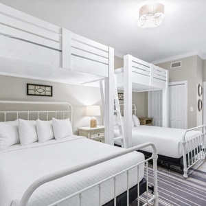Unwind in this guest room featuring two queen beds, two loft twin bunk beds, and a cozy atmosphere
