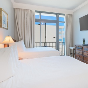 Unwind in this guest suite on one of the double beds and stream your favorite shows enjoying the balcony view