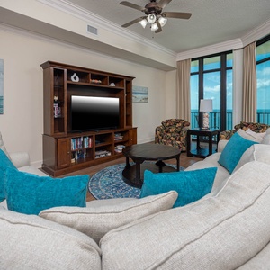 Relax on the plush sectional, watching a movie while soaking in the stunning views of the beach