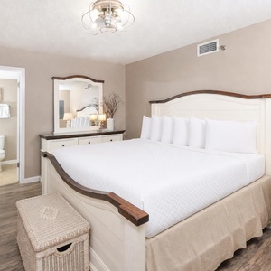 Inviting guest bedroom featuring a king bed, stylish decor, and a warm atmosphere for restful nights