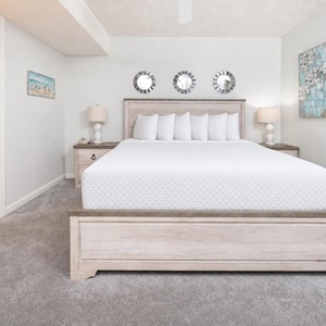 Plush pillows line your king suite bed, perfect for resting after a day along the shore