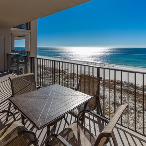 Enjoy meals at the balcony table while enjoying expansive views and gentle breezes from this inviting space