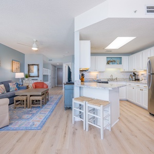 Bright white cabinets surround your kitchen where you can gather around the breakfast bar stools