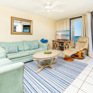 Mint green sofas invite you to relax in the living room while watching the sun glide across the shore from your balcony