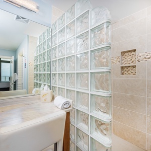 Pamper yourself in the master bath shower area, where your morning routine becomes a refreshing beachside ritual