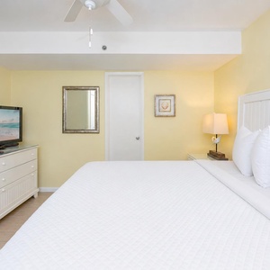 Calm your mind in the king suite where the bed invites restful sleep after a day on the shore