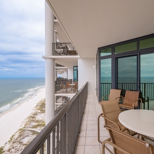 Enjoy stunning views from the spacious balcony, featuring comfortable seating and a table for outdoor dining