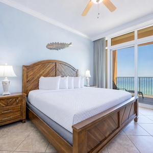 The king master suite welcomes you to unwind on plush bedding while the coast stretches beyond sliding doors