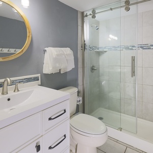 Modern bathroom featuring a sleek vanity, a spacious glass shower, and modern fixtures for a refreshing experience