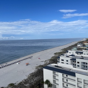 Scan the shoreline from the balcony as gentle gulf waves roll toward the horizon