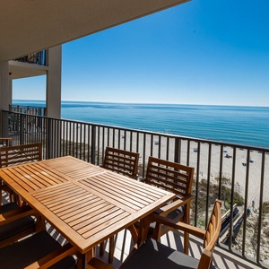 Enjoy meals or drinks at the outdoor table while taking in the tranquil views of the water and beach below