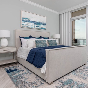 Retreat to the king master suite with cozy bedding and drift off to the sound of the waves from the balcony