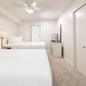 Rest easy in this comfortable guest bedroom with two queen beds, enjoying restful nights on fluffy pillows