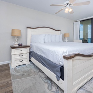 Master bedroom featuring a plush king bed and stunning views from the balcony, perfect for relaxation