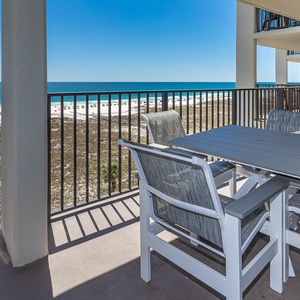 Balcony seating offers a perfect spot to enjoy the gulf view and white sand beach, ideal for relaxation and dining