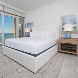 Retreat to the king master suite with cozy bedding and drift off to the sound of the waves from the balcony