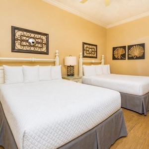 Two double beds in the guest suite invite restful nights and cozy mornings during your beachside getaway