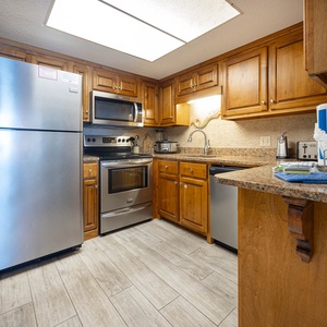 This kitchen features stainless appliances, granite countertops, and a cozy atmosphere perfect for preparing meals
