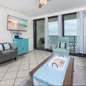 Bright and airy living area featuring a cozy sofa with queen sleeper, stylish chairs, and breathtaking beachfront views