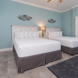 Sleep peacefully in plush queen beds while enjoying the calming coastal vibes in this serene guest suite