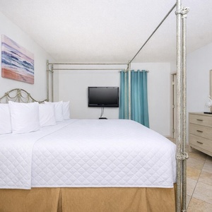 Enjoy a peaceful rest in the king master suite surrounded by fluffy pillows and cozy bedding