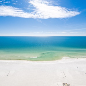 Experience seemingly endless coastline views of the horizon as waves lap the shore and the sun glistens over the water