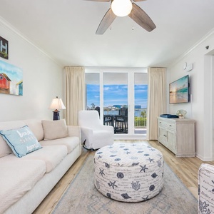 Bright living room invites you to relax while the balcony doors reveal shimmering gulf waters beyond