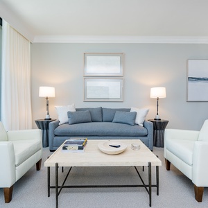 Relaxing living area with comfortable seating, queen sofa sleeper, large TV, and breathtaking beachfront views